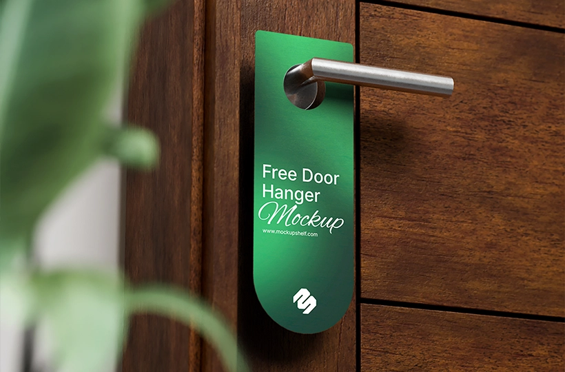 Free Door Tag Mockup – front side angled view on wooden door with potted plants | MockupShelf