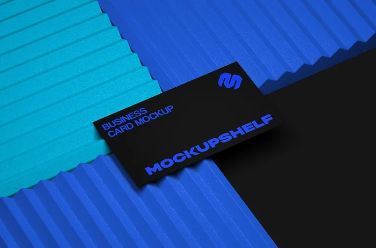 Black business card placed on layered blue textured surfaces