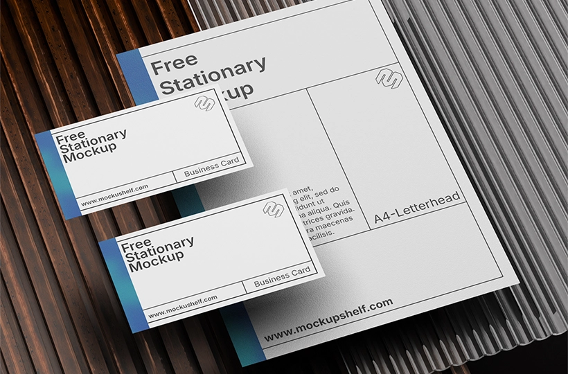 Stationery Items Mockup Design – top angled view of letterhead and business cards on textured surface | MockupShelf
