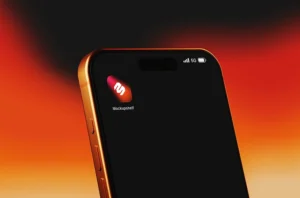 Free cinematic phone mockup PSD - angled smartphone home screen with dramatic orange glow background