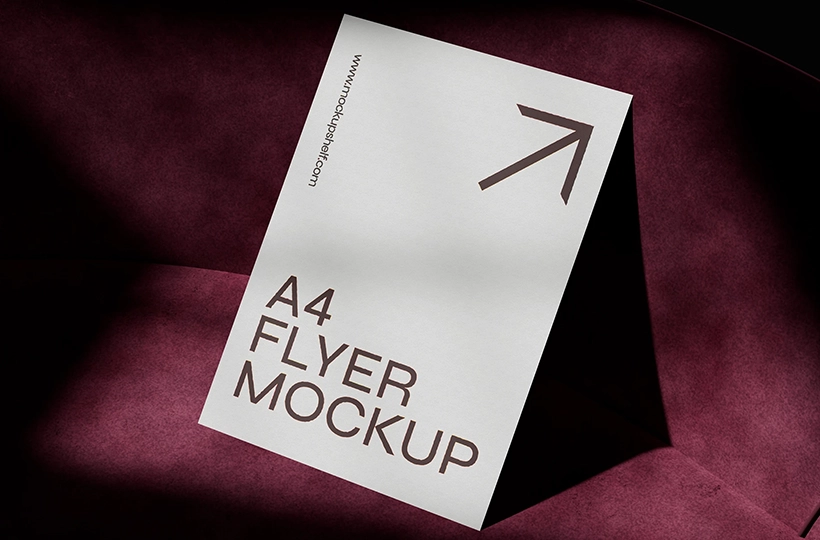 Standing A4 flyer mockup with a dark burgundy velvet background